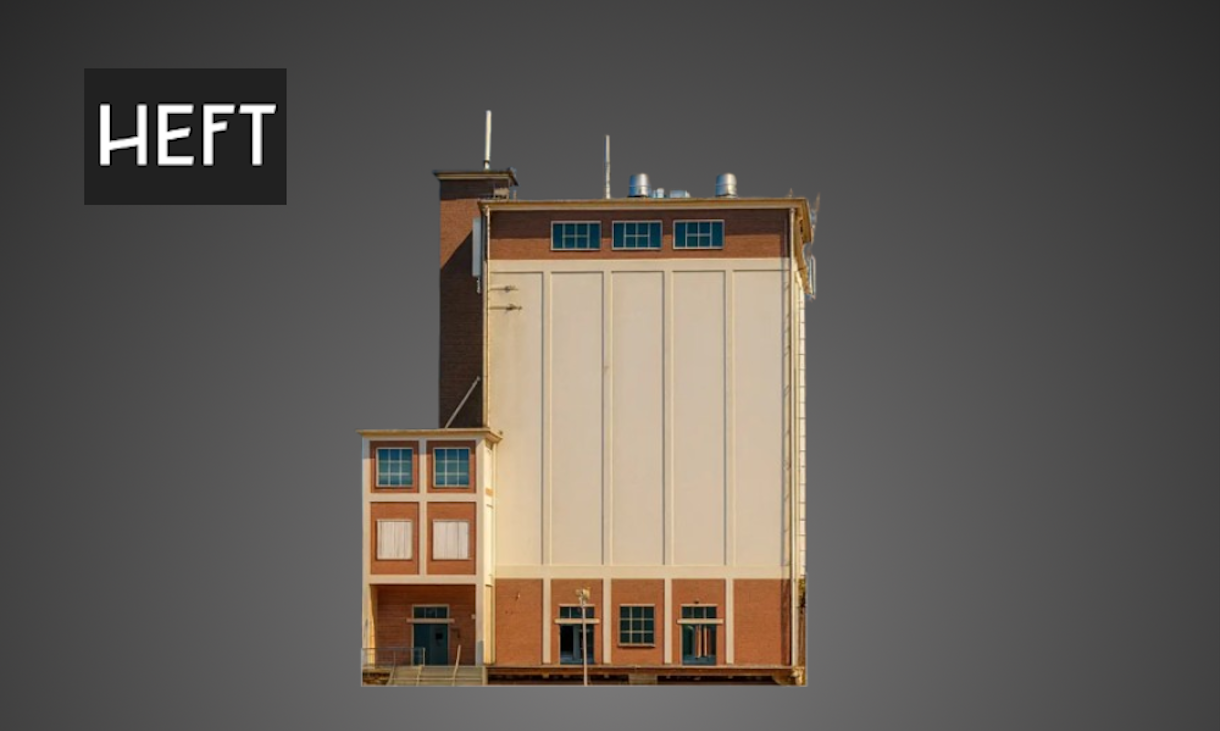 Vooraanzicht van een monumentale graansilo met HEFT-logo linksboven.
